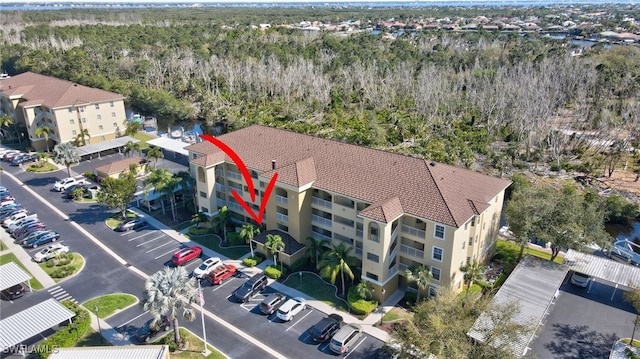 birds eye view of property featuring a view of trees