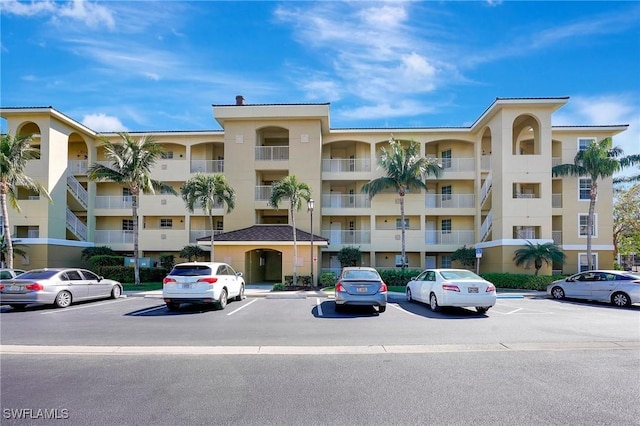 view of building exterior featuring uncovered parking