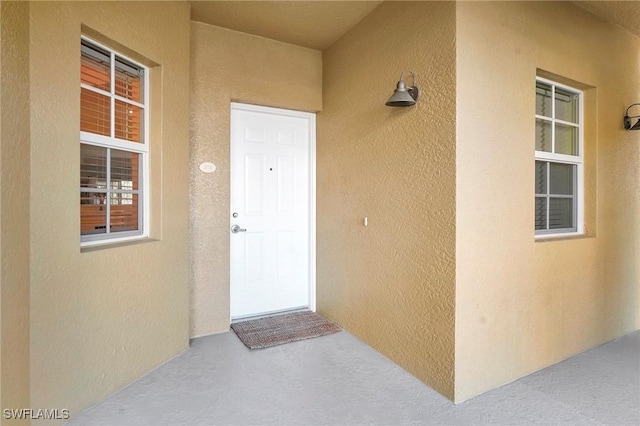 doorway to property with stucco siding