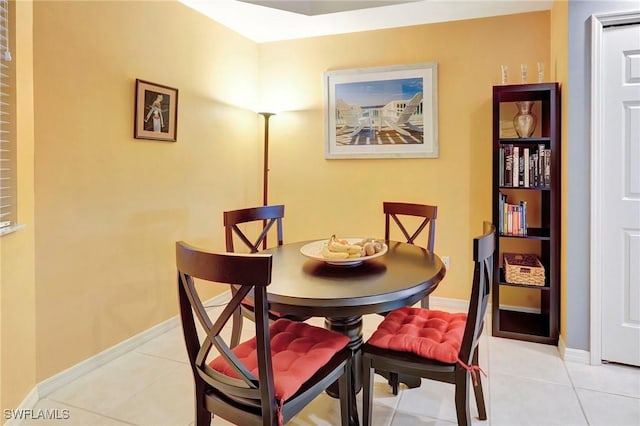 dining area with baseboards and light tile patterned floors