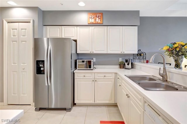 kitchen with dishwasher, white cabinets, a sink, and stainless steel fridge with ice dispenser