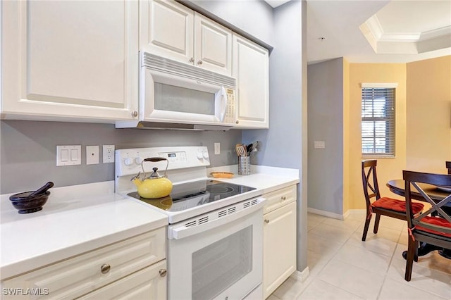 kitchen featuring white appliances, light countertops, crown molding, white cabinetry, and light tile patterned flooring