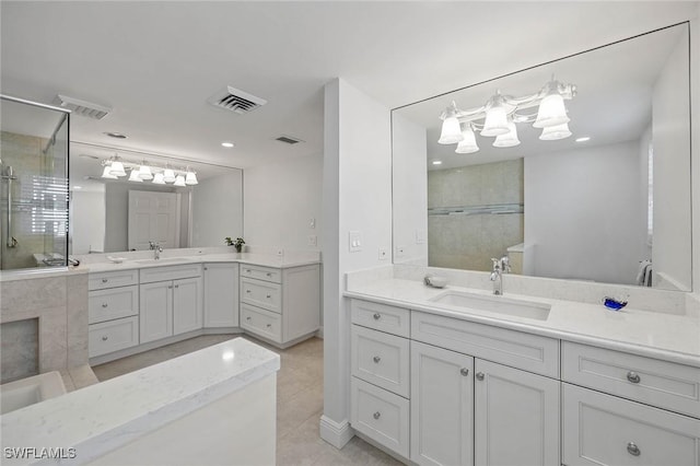 bathroom with visible vents, a sink, and tiled shower