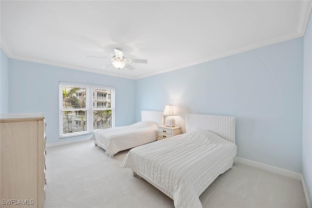 bedroom with carpet floors, ornamental molding, baseboards, and ceiling fan