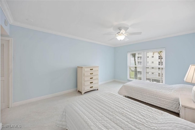 bedroom featuring a ceiling fan, baseboards, crown molding, and light colored carpet