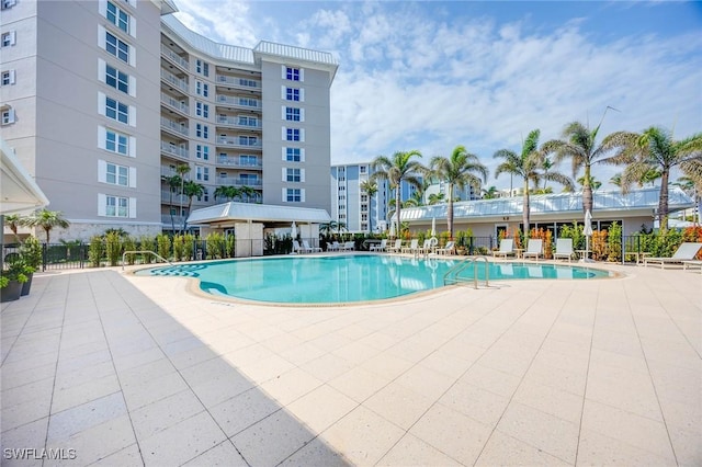 pool featuring a patio area and fence