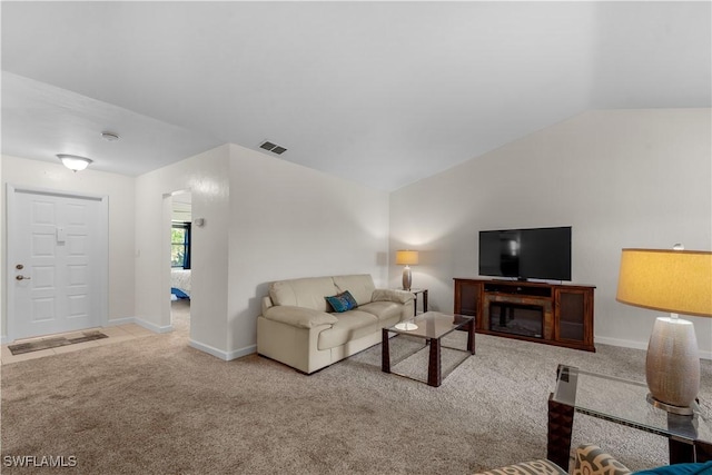 living area featuring lofted ceiling, carpet, visible vents, and baseboards