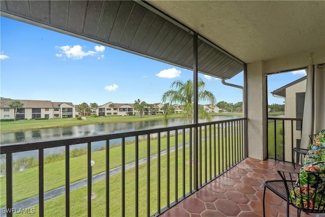 balcony featuring a residential view and a water view