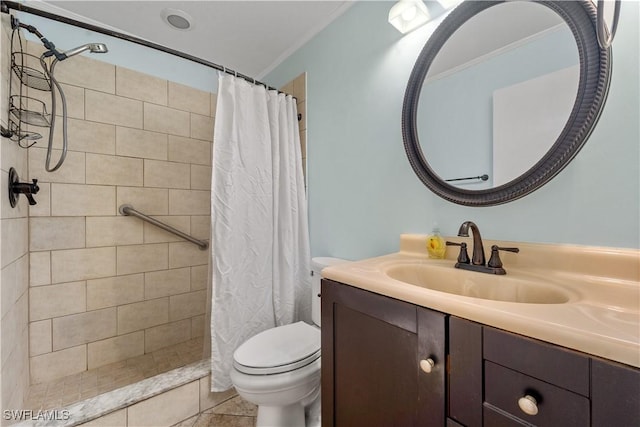 bathroom with toilet, ornamental molding, a tile shower, vanity, and tile patterned flooring