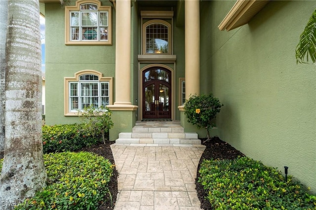 doorway to property with french doors and stucco siding