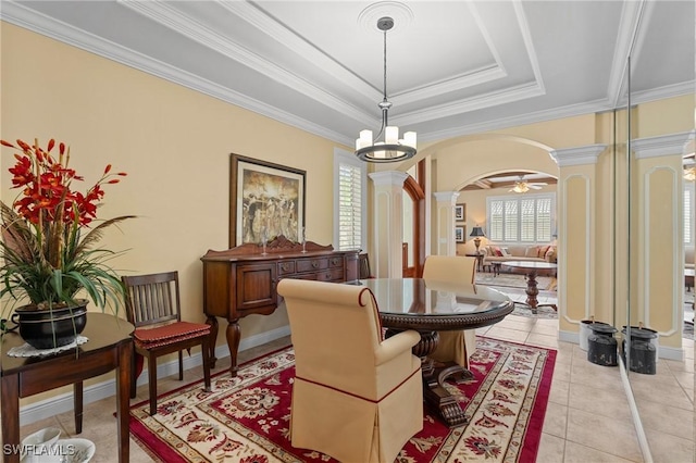 sitting room with ornate columns, plenty of natural light, arched walkways, and a raised ceiling