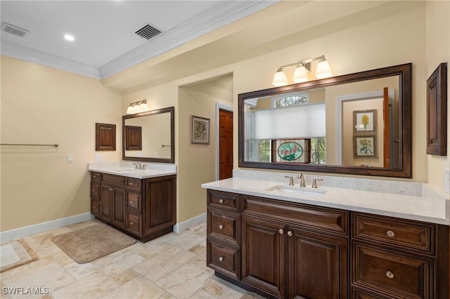 full bathroom featuring ornamental molding, two vanities, a sink, and visible vents