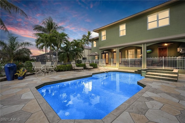 view of swimming pool with a patio area, fence, and a fenced in pool