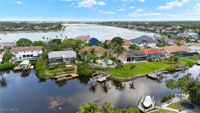 drone / aerial view with a water view and a residential view