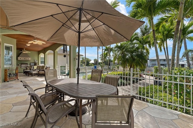 view of patio / terrace featuring fence, a ceiling fan, and outdoor dining space