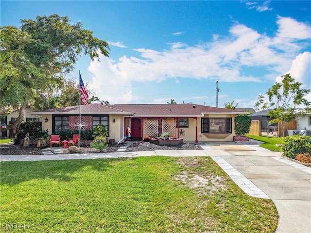 ranch-style home with stucco siding and a front yard