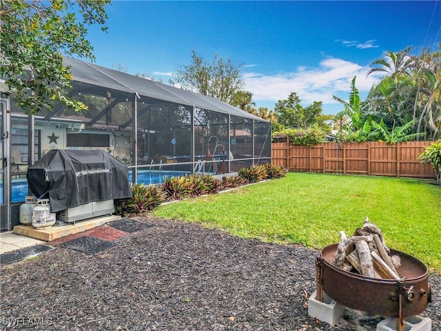 view of yard with a pool, a lanai, and a fenced backyard