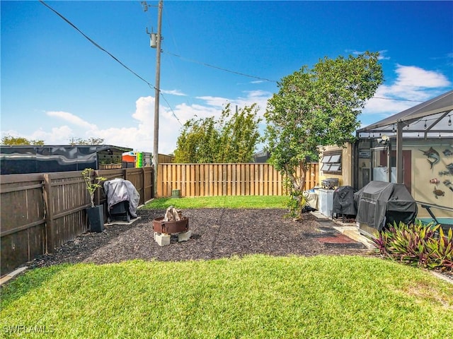 view of yard featuring an outdoor fire pit and a fenced backyard