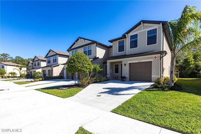 view of front facade featuring concrete driveway, an attached garage, a residential view, and a front yard