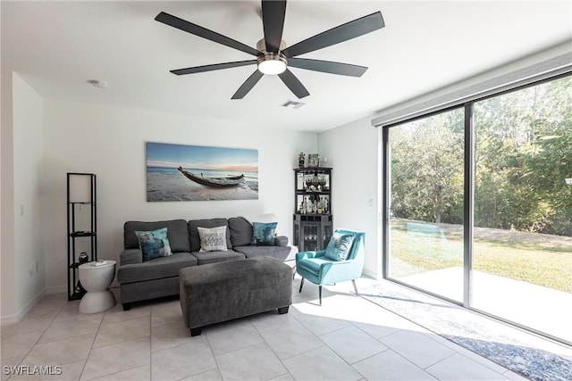 14239 Oviedo Pl, Fort Myers, FL 33905 - living room with light tile patterned floors, visible vents, and a ceiling fan