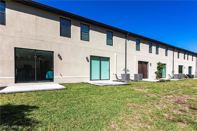 14239 Oviedo Pl, Fort Myers, FL 33905 - back of property featuring central AC unit, a lawn, and stucco siding