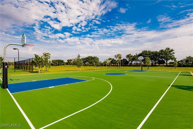 14239 Oviedo Pl, Fort Myers, FL 33905 - view of basketball court with community basketball court, a lawn, and fence