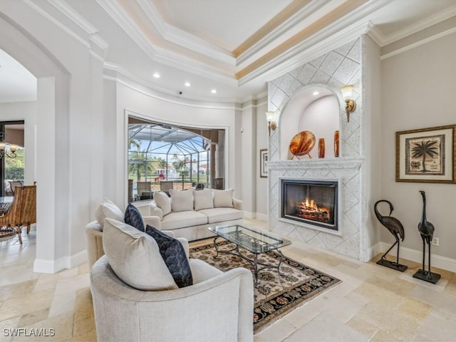 living room with stone tile flooring, plenty of natural light, and baseboards