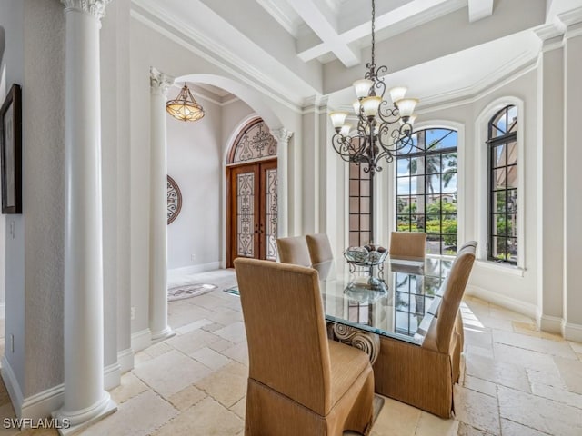 dining room with coffered ceiling, stone tile floors, arched walkways, baseboards, and ornate columns