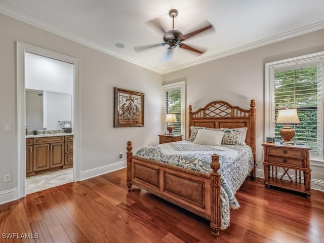 bedroom featuring connected bathroom, baseboards, light wood finished floors, and ornamental molding