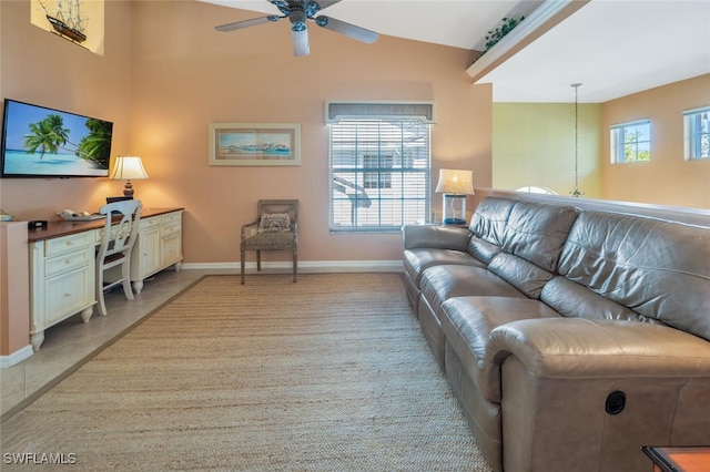 living room with baseboards, high vaulted ceiling, a healthy amount of sunlight, and ceiling fan