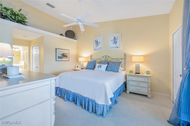 carpeted bedroom with a ceiling fan, baseboards, visible vents, lofted ceiling, and a closet