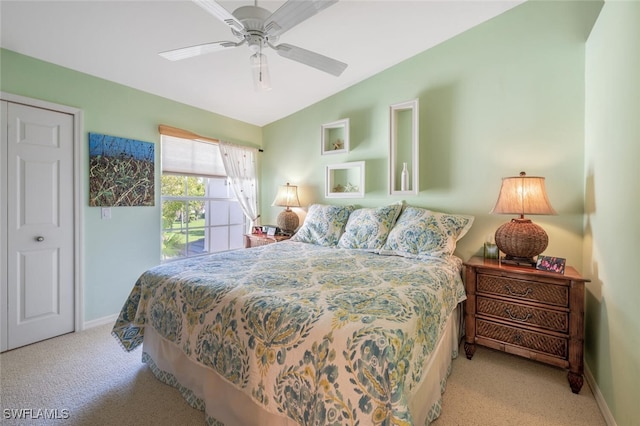 carpeted bedroom with vaulted ceiling, baseboards, and ceiling fan