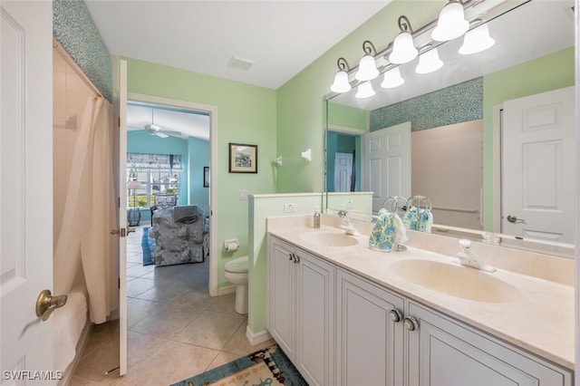 bathroom with tile patterned floors, visible vents, toilet, and a sink