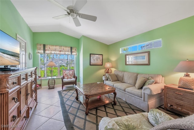 living area with light tile patterned floors, a ceiling fan, and vaulted ceiling