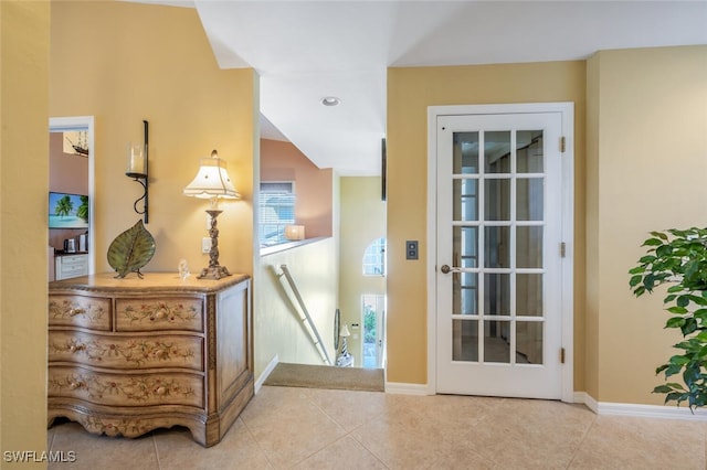 entryway with recessed lighting, baseboards, and tile patterned flooring