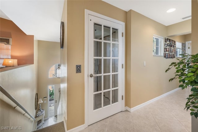 interior space with baseboards and tile patterned flooring