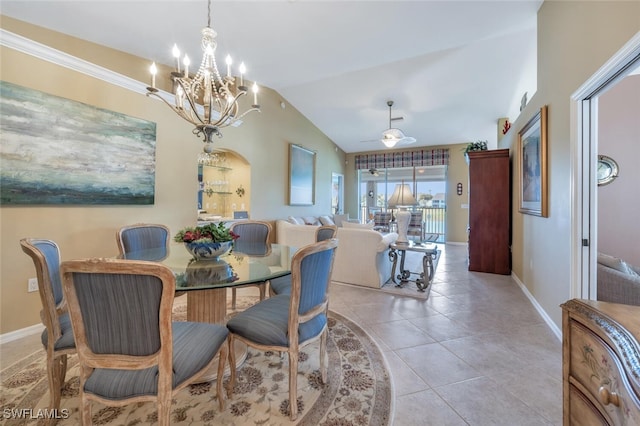 dining room featuring lofted ceiling, ceiling fan with notable chandelier, arched walkways, light tile patterned floors, and baseboards