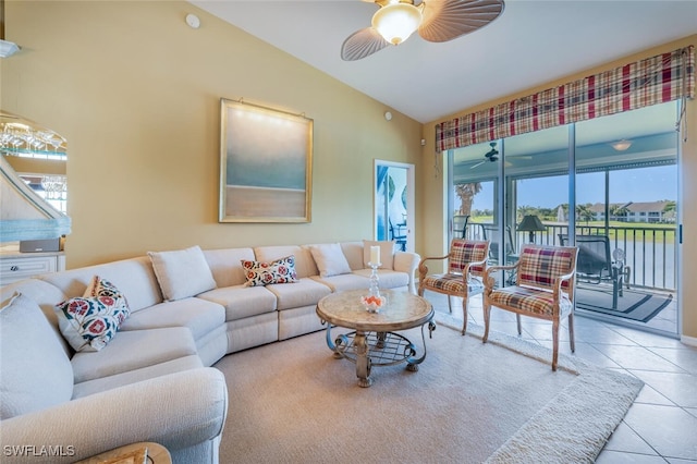 tiled living room featuring ceiling fan and vaulted ceiling