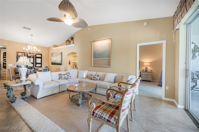 living area with visible vents, vaulted ceiling, light tile patterned floors, ceiling fan with notable chandelier, and arched walkways