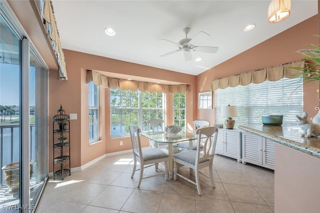 dining room featuring recessed lighting, baseboards, light tile patterned flooring, and vaulted ceiling