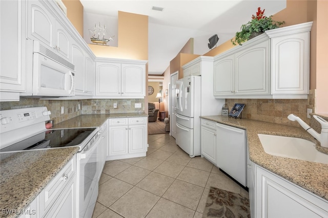 kitchen featuring visible vents, a sink, white cabinetry, white appliances, and light tile patterned flooring