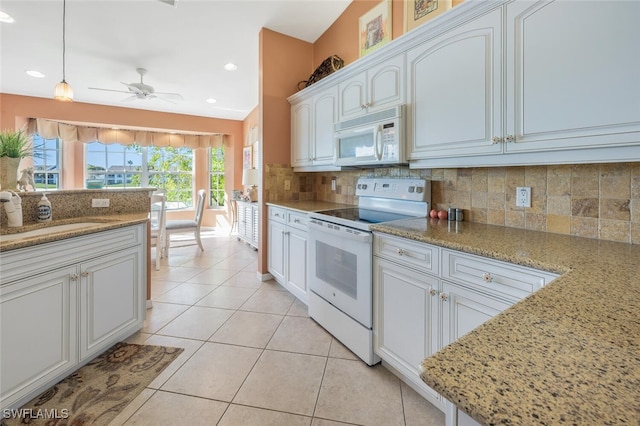 kitchen featuring a sink, tasteful backsplash, white cabinetry, white appliances, and light tile patterned floors