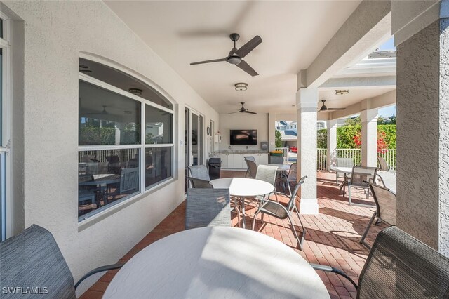 view of patio / terrace with outdoor dining area and a ceiling fan