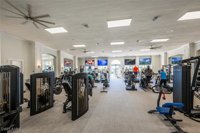 workout area with carpet flooring, visible vents, and ornamental molding