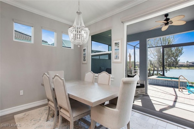 dining area with crown molding, wood finished floors, baseboards, and a water view