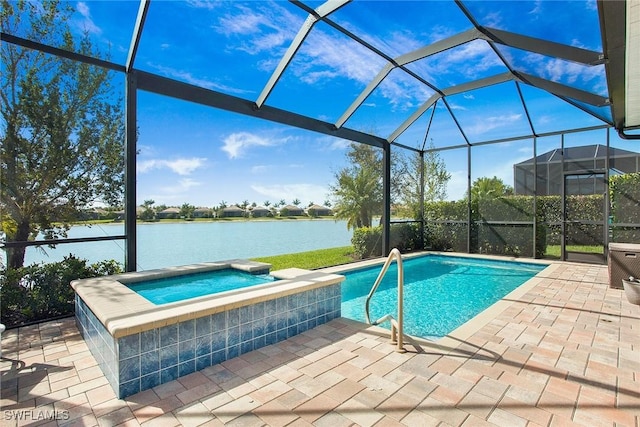 outdoor pool featuring glass enclosure, a patio, an in ground hot tub, and a water view