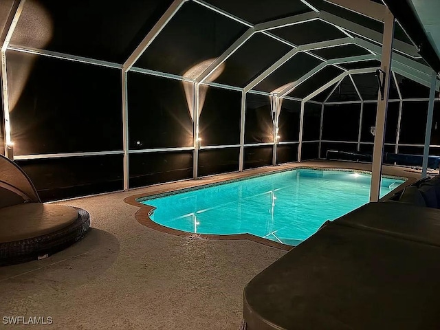 pool featuring a lanai and a patio area