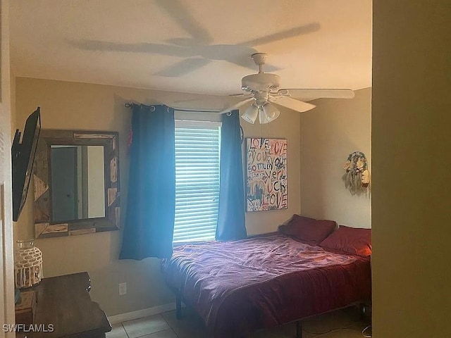 bedroom with a ceiling fan and tile patterned flooring