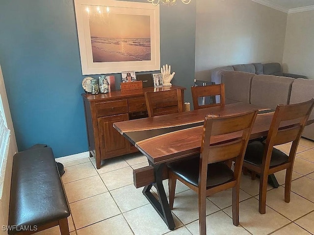 dining room featuring light tile patterned floors, baseboards, and crown molding