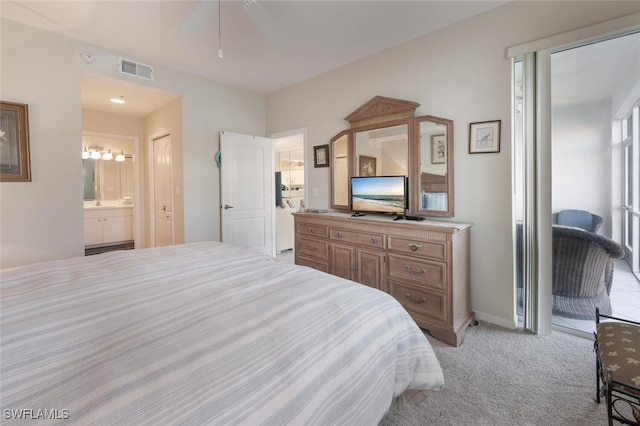 bedroom with a ceiling fan, baseboards, visible vents, light colored carpet, and connected bathroom